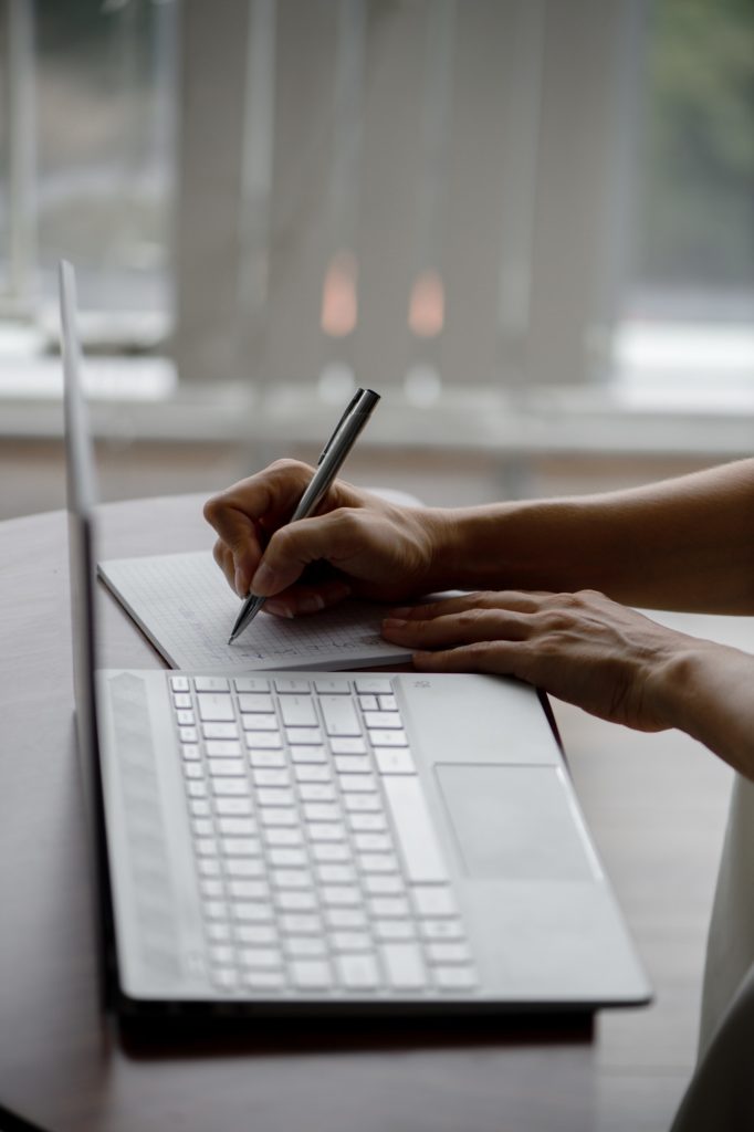 Business woman. A girl with a diary and a laptop. Girl's hands